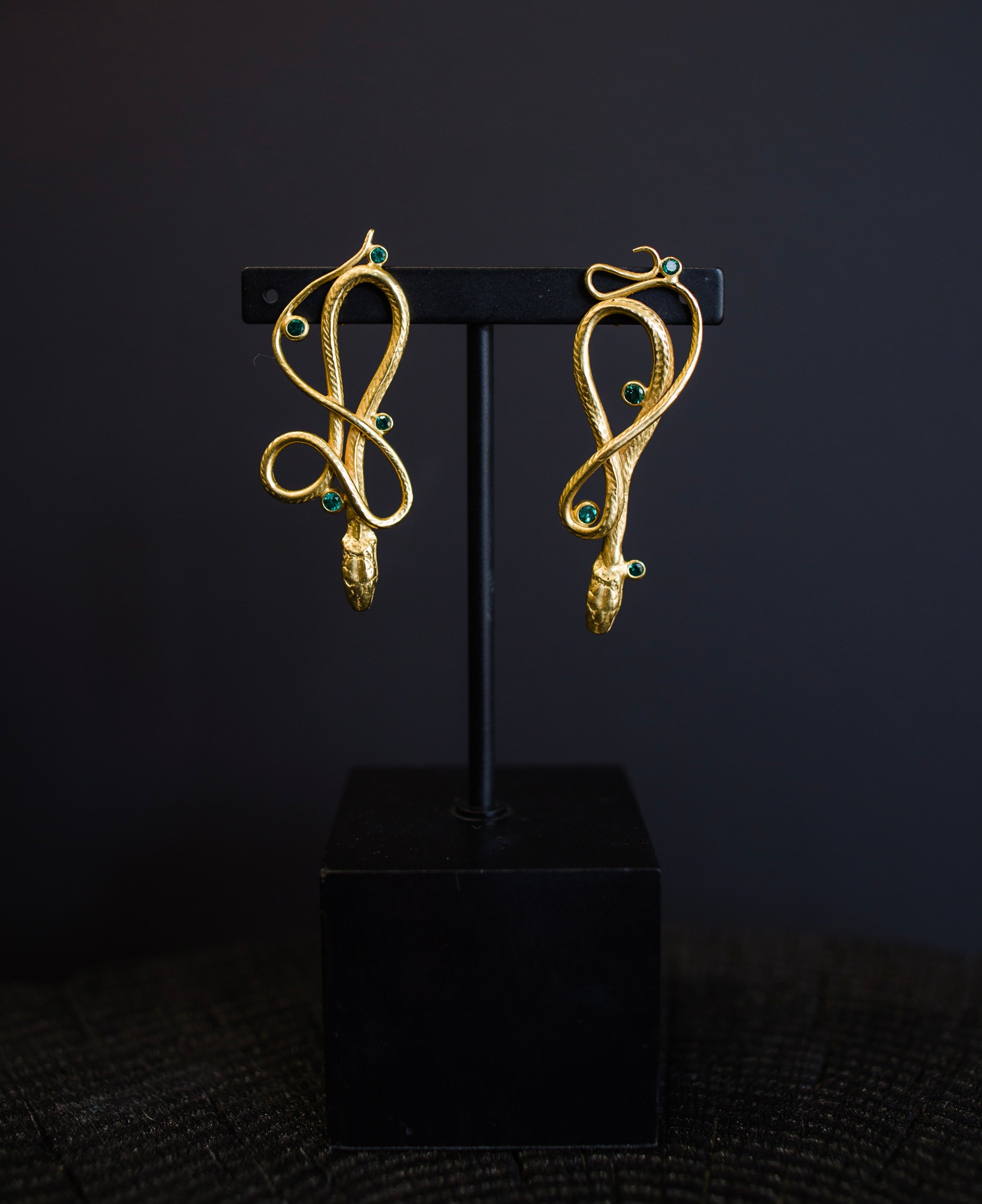 Image featuring 18k gold & Emerald Serpentine Earrings handmade by North Carolina artist Anna Johnson with emeralds, 18k gold vermeil over silver and bronze castings