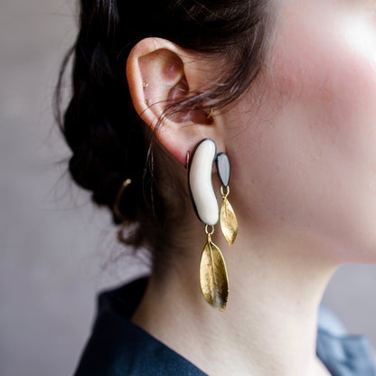 Image featuring a woman wearing North Carolina artist and jeweler Anna Johnson Anzia Earrings with Antique Coral, Moonstone, 18k over bronze, silver and mountain laurel castings