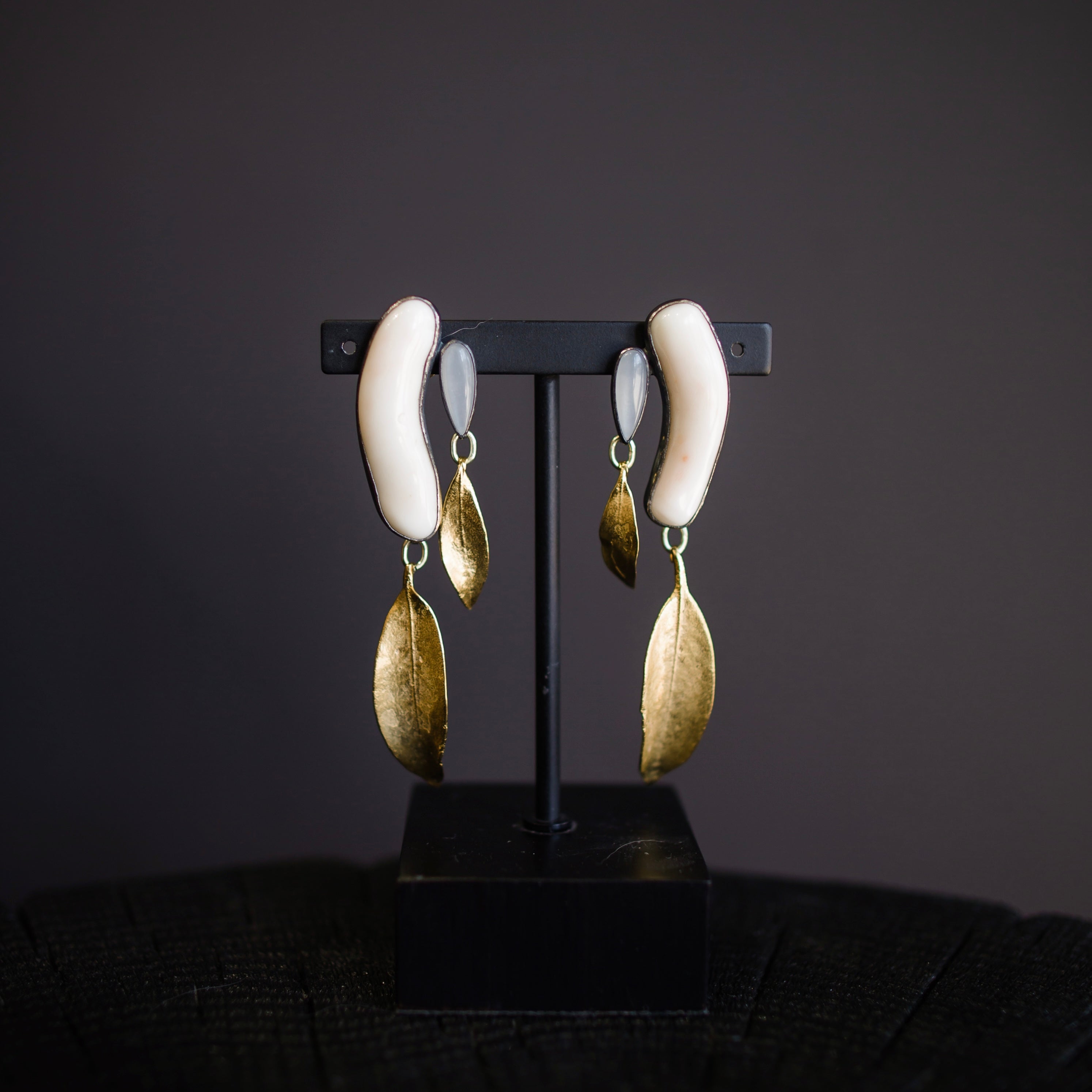 Image featuring North Carolina artist and jeweler Anna Johnson Anzia Earrings with Antique Coral, Moonstone, 18k over bronze, silver and mountain laurel castings