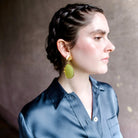 Image featuring a woman wearing handmade earrings by North Carolina artist Anna Johnson with Lemon quartz, rodent mandibles, 18k gold vermeil over silver