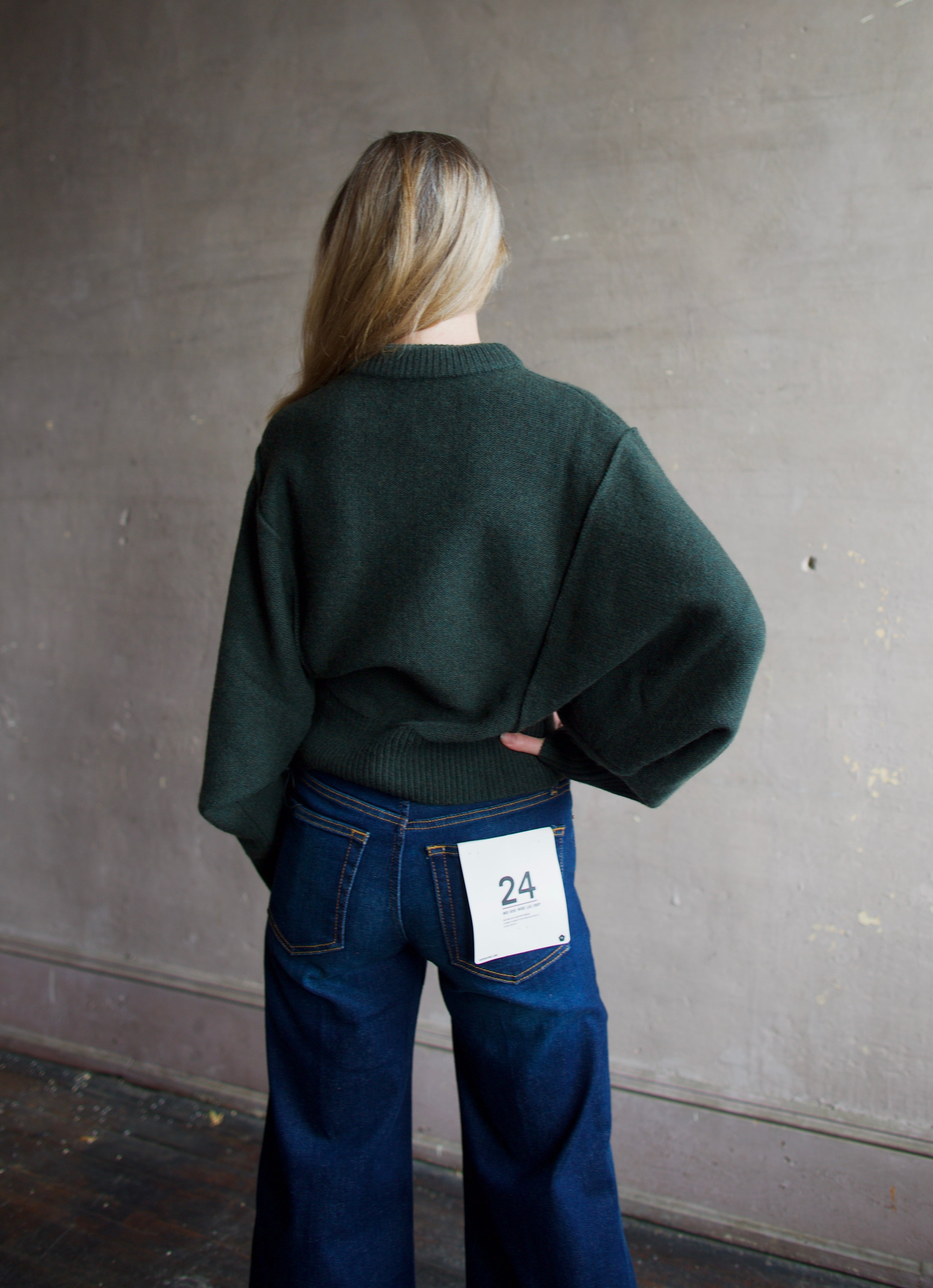 Image of the back of a woman wearing the Apiece Apart  Alina Dolman Sweater and Re/Done Wide Leg Crop Jeans