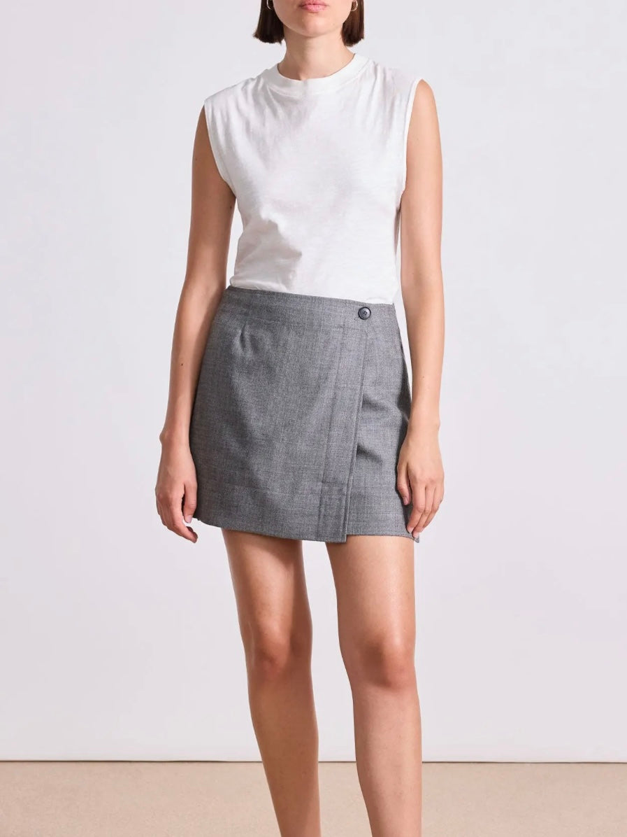 Model wearing Apiece Apart Marta mini skirt in sophisticated neutral heathered grey in virgin wool