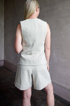 Back image of a woman wearing the Apiece Apart Helena Vest and Linaza Shorts