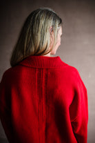 Image featuring a woman wearing the red cotton sweater by Apiece Apart with a split neckline, collar and back seam detailing in a relaxed fit.