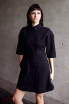 Model wearing comfortable Apiece Apart Luz black shirt mini dress with 3/4 sleeves in cotton and linen mix