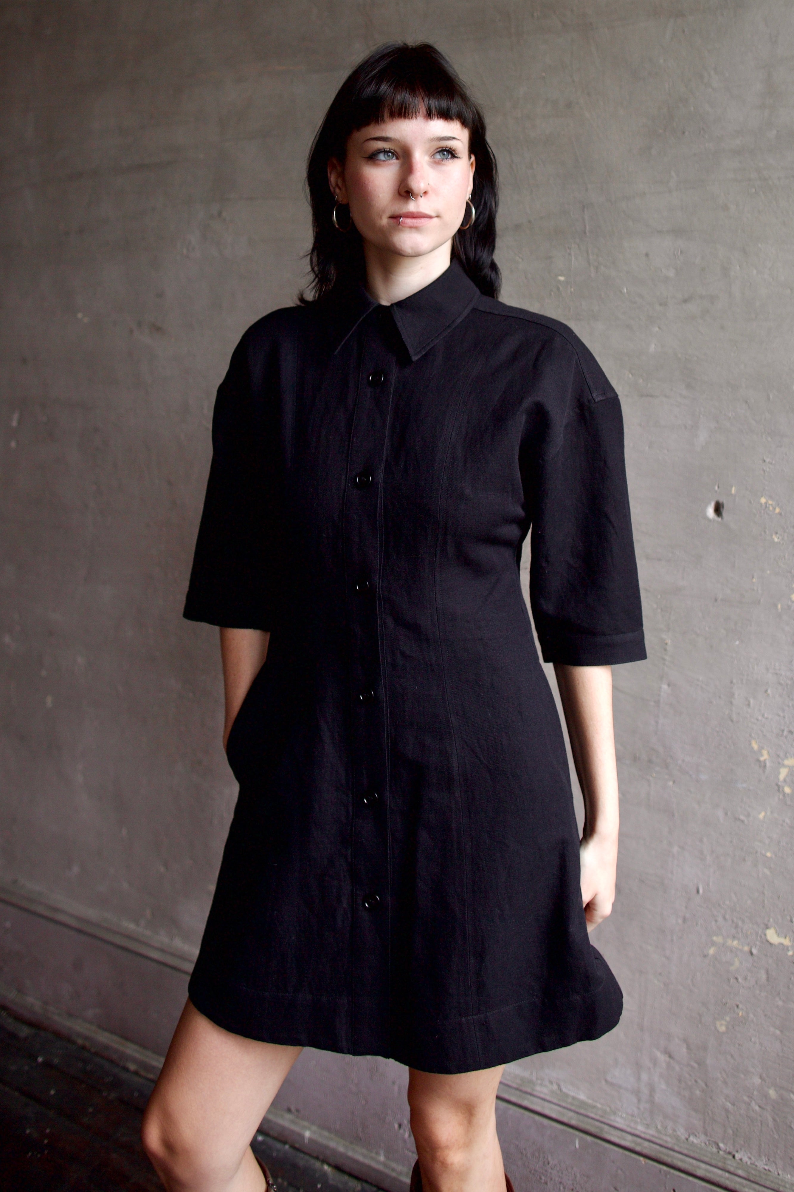 Model wearing comfortable Apiece Apart Luz black shirt mini dress with 3/4 sleeves in cotton and linen mix
