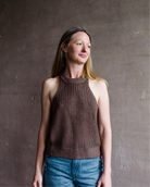 Image featuring a woman wearing the Apiece Apart Ori linen sweater is an easy sweater featuring a racerback and ribbed details throughout.