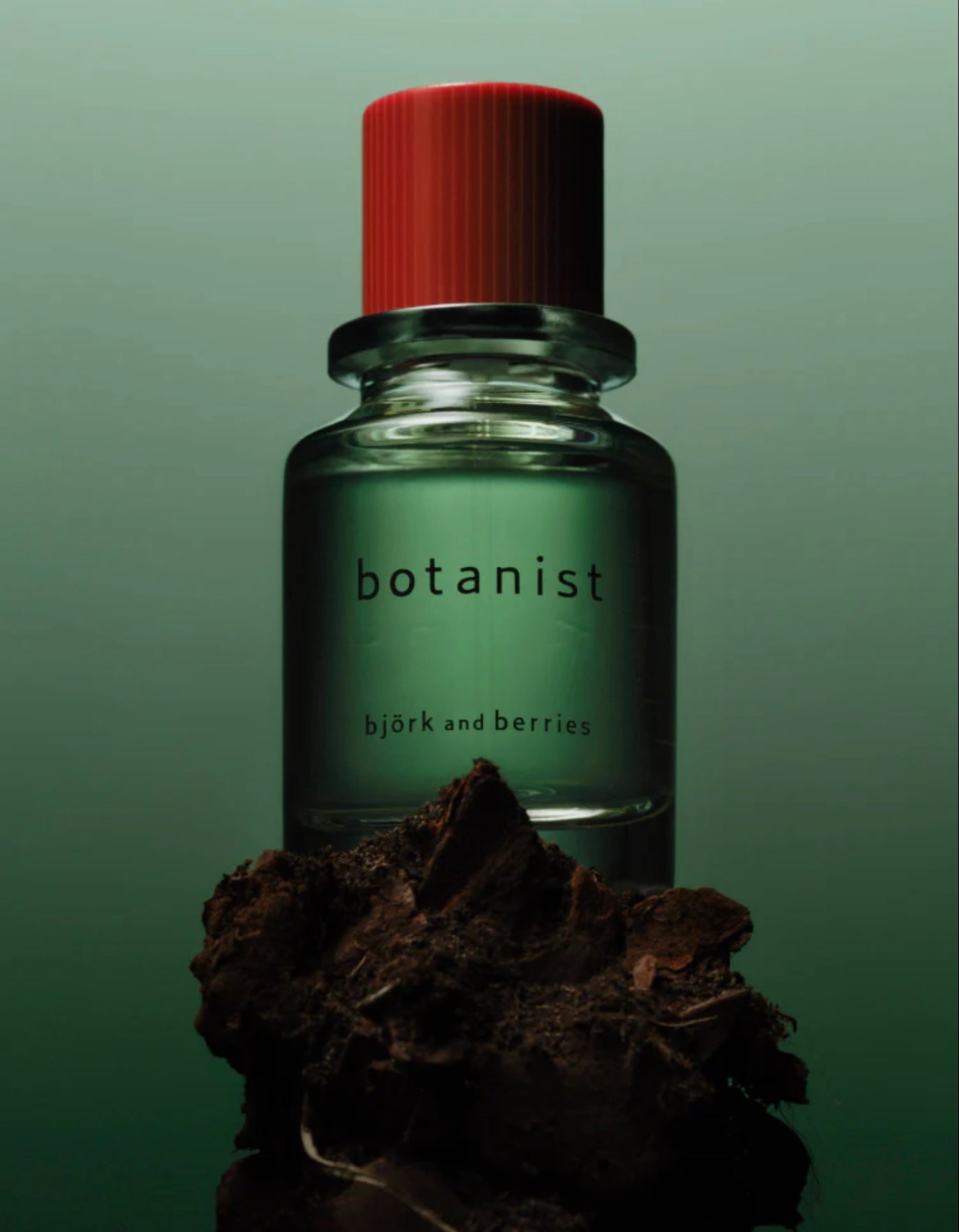 Image of BJORK AND BERRIES Botanist luxury personal fragrance eau de parfum with notes of green apple, vetiver and patchouli in a Scandinavian minimalist design clear glass bottle and red lid