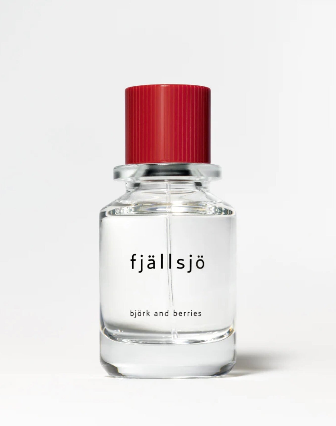 Image of BJORK AND BERRIES Fjallsjo luxury personal fragrance eau de parfum with notes of Ambrette, Magnolia and Musk in a Scandinavian minimalist design clear glass bottle and red lid