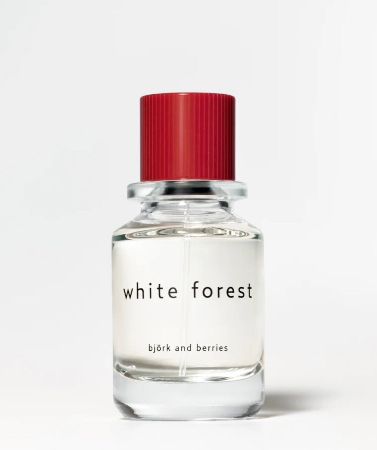 Image of BJORK AND BERRIES White Forest luxury personal fragrance eau de parfum with notes of Bergamot, Tonka Bean and Vetiver in a Scandinavian minimalist design clear glass bottle and red lid