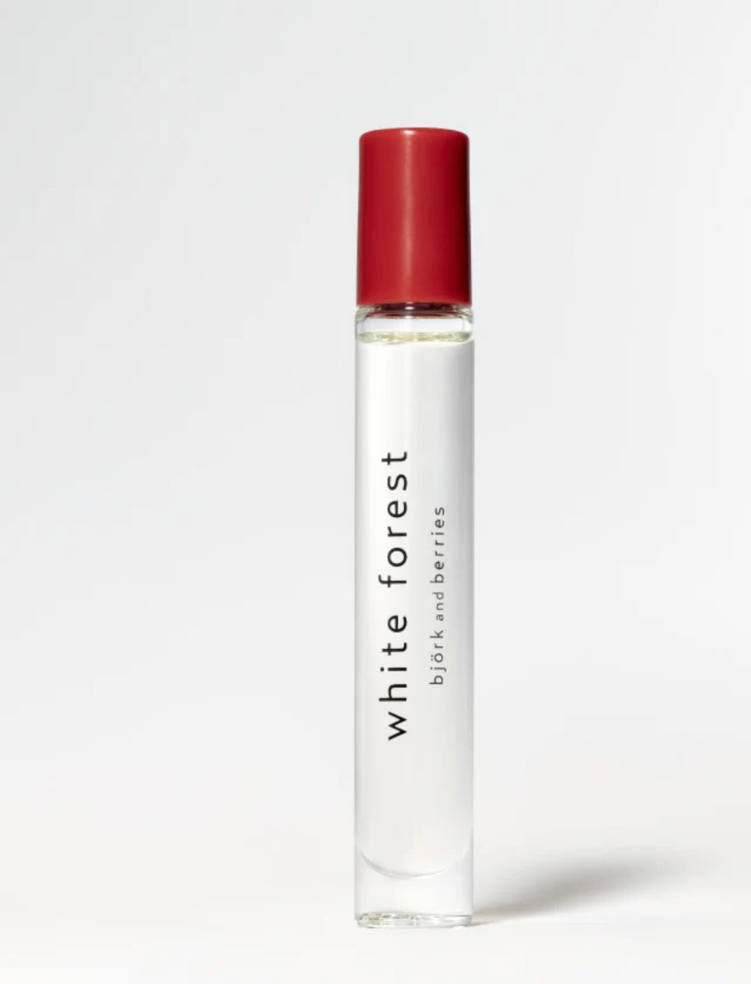 Image of BJORK AND BERRIES White Forest luxury personal fragrance perfume oil with notes of Bergamot, Tonka Bean and Vetiver in a Scandinavian minimalist design clear glass bottle and red lid