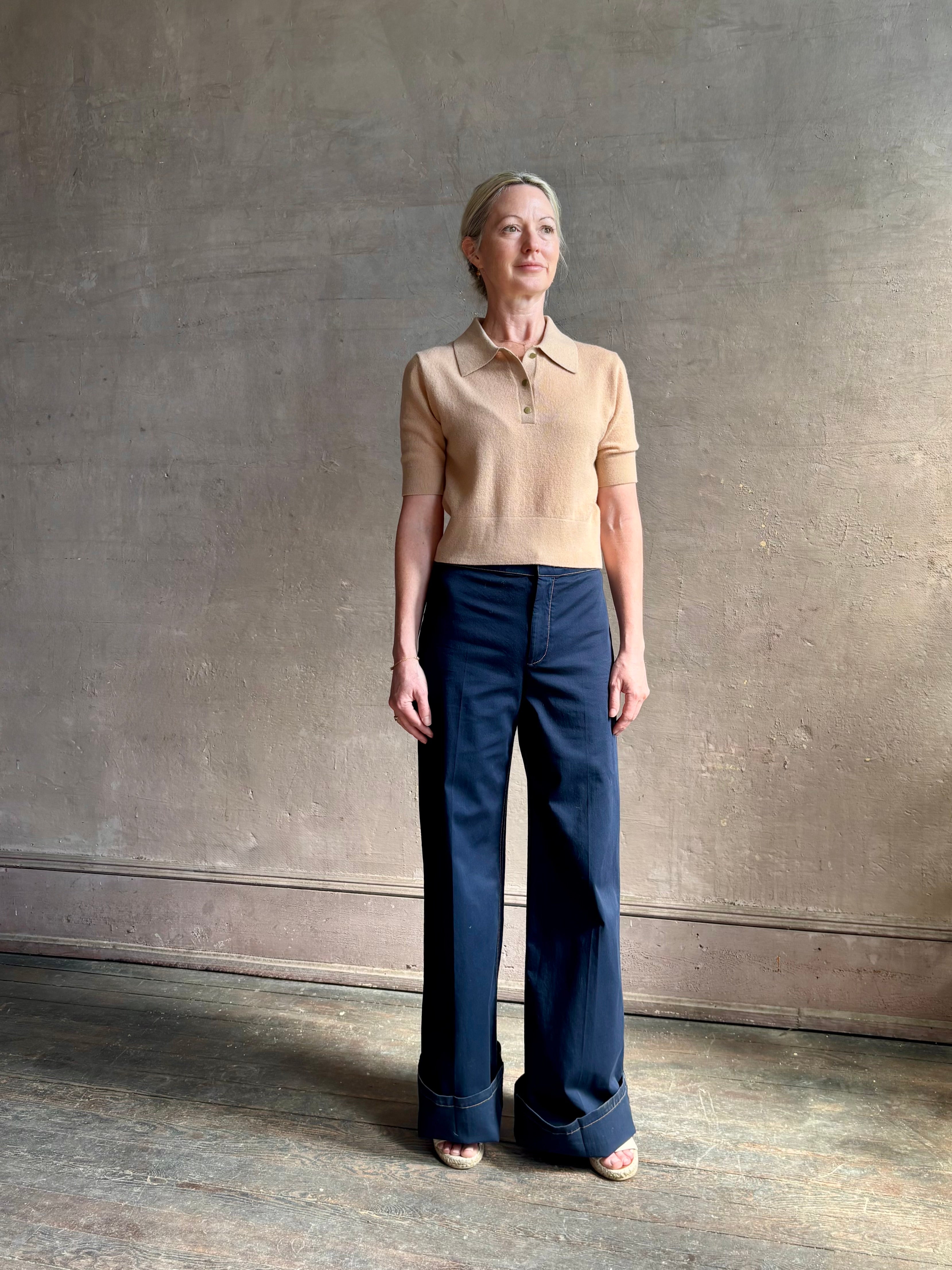 Mature woman wearing the European tailored Jane Pant from Callas rendered in a timeless navy and crafted from a stretchy cotton blend featuring yellow stitching, a clean flat front and flattering back pockets