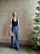 Mature woman wearing Italian designer Tonne trouser from Callas rendered in a dark indigo and crafted from a viscose, polyester, and linen blend with beautiful fluid draping and effortless versitility similar to denim