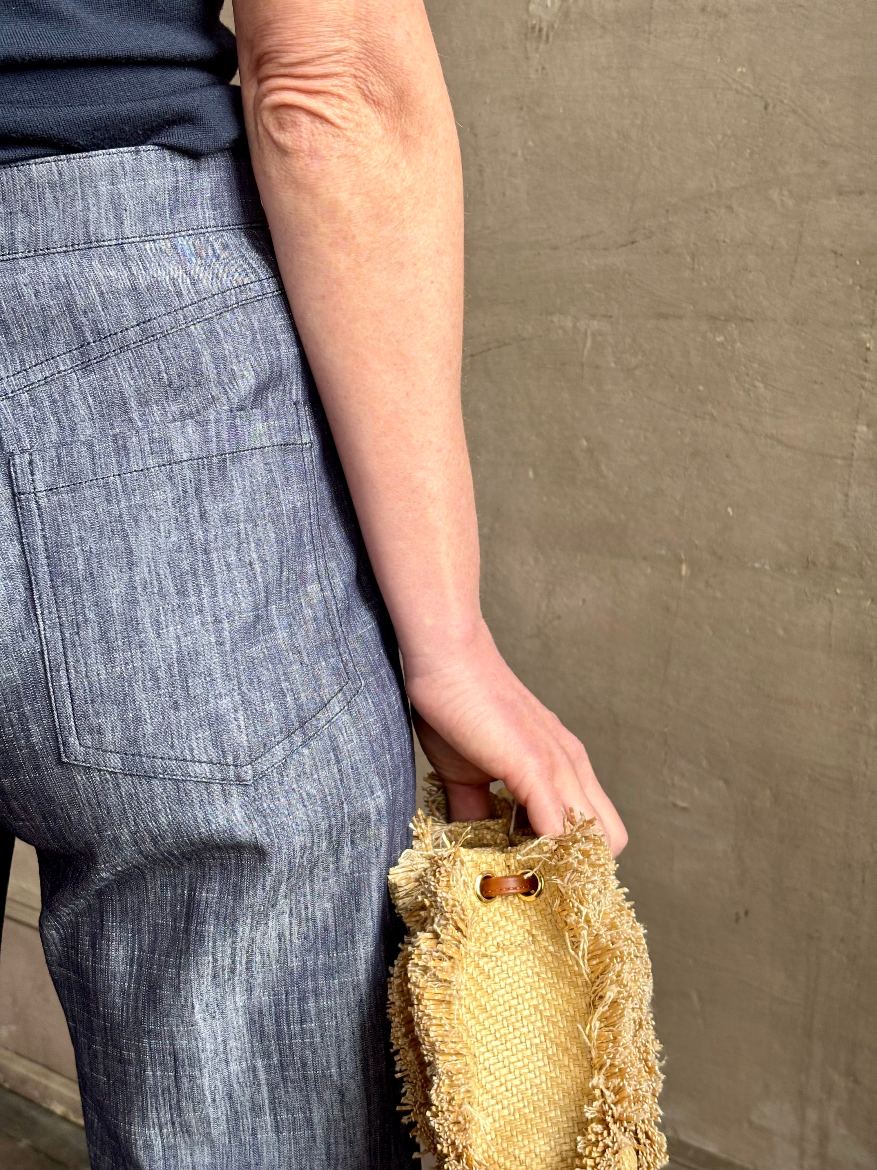 Mature woman wearing Italian designer Tonne trouser from Callas rendered in a dark indigo and crafted from a viscose, polyester, and linen blend with beautiful fluid draping and effortless versitility similar to denim
