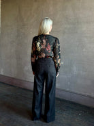 Mature woman wearing Cara Cara Chili Blouse in Meadows Black linen-silk  crystal buttons Romantic dressmaker-quality occasion ready