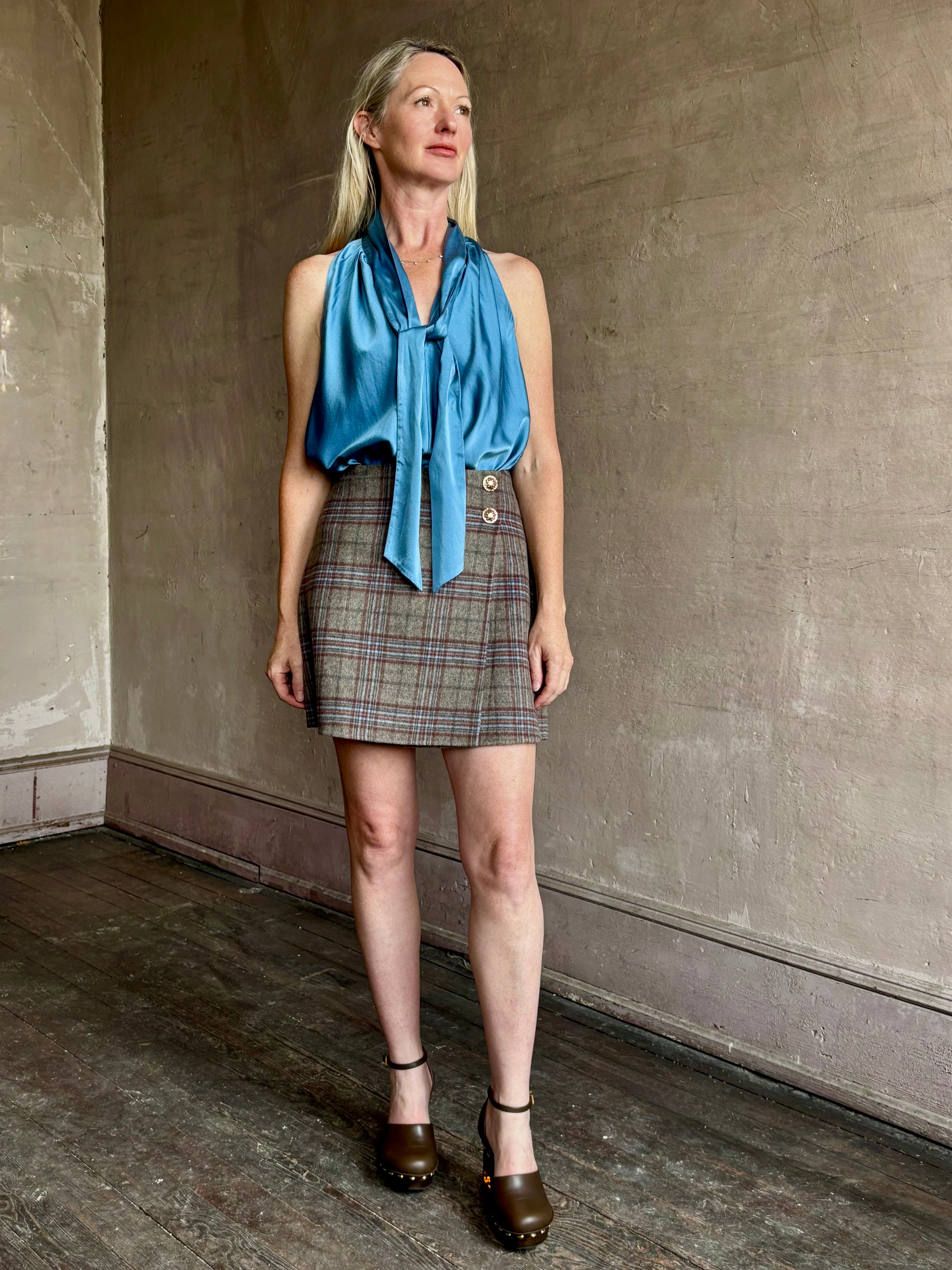 Image of woman wearing the classic Allen Plaid A-Line Mini Skirt from Cara Cara in a premium wool blend