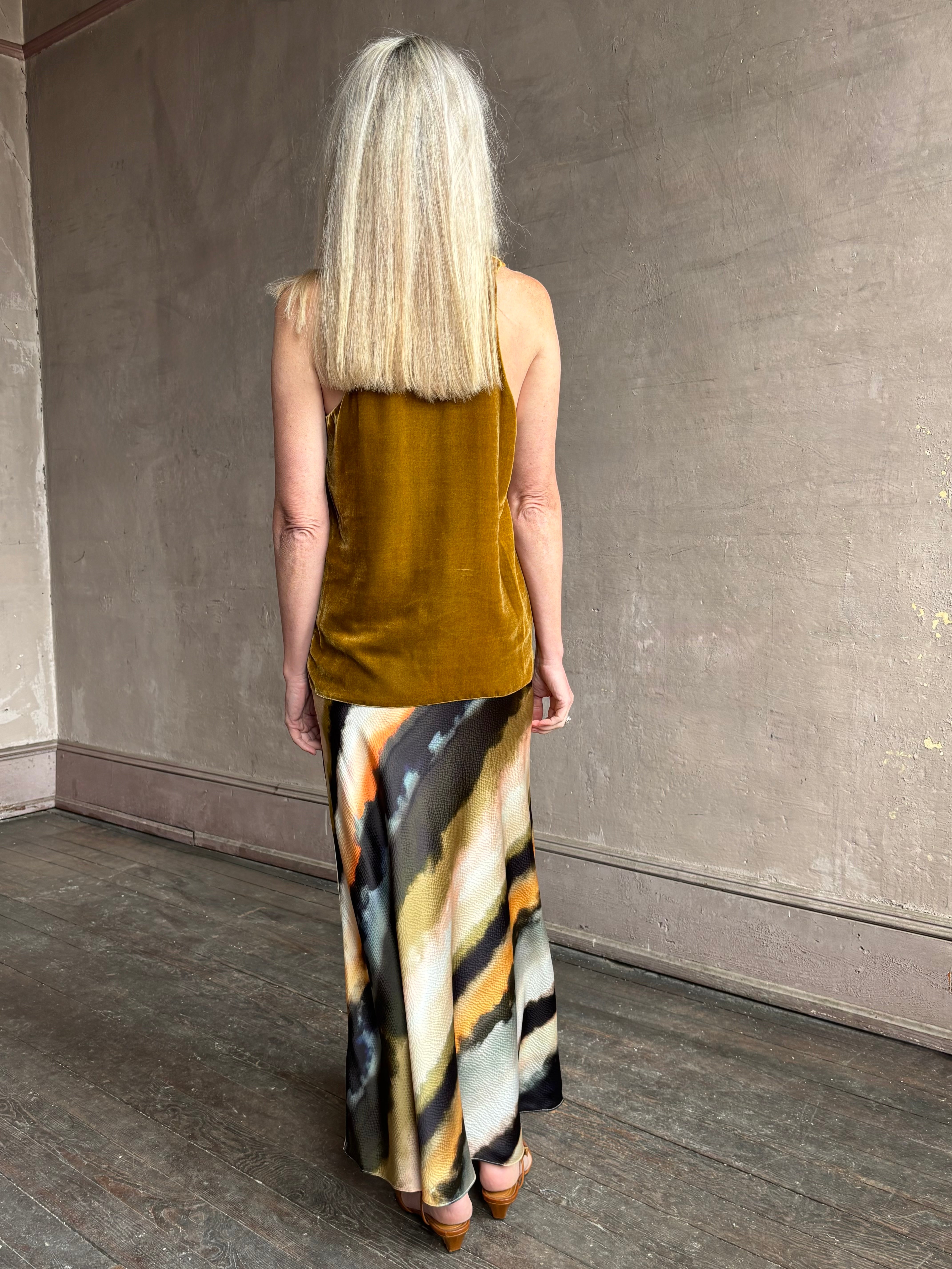 Image of mature woman wearing  designer Cara Cara hammered silk maxi slip skirt with abstract multi-color print that can be dressed up or down