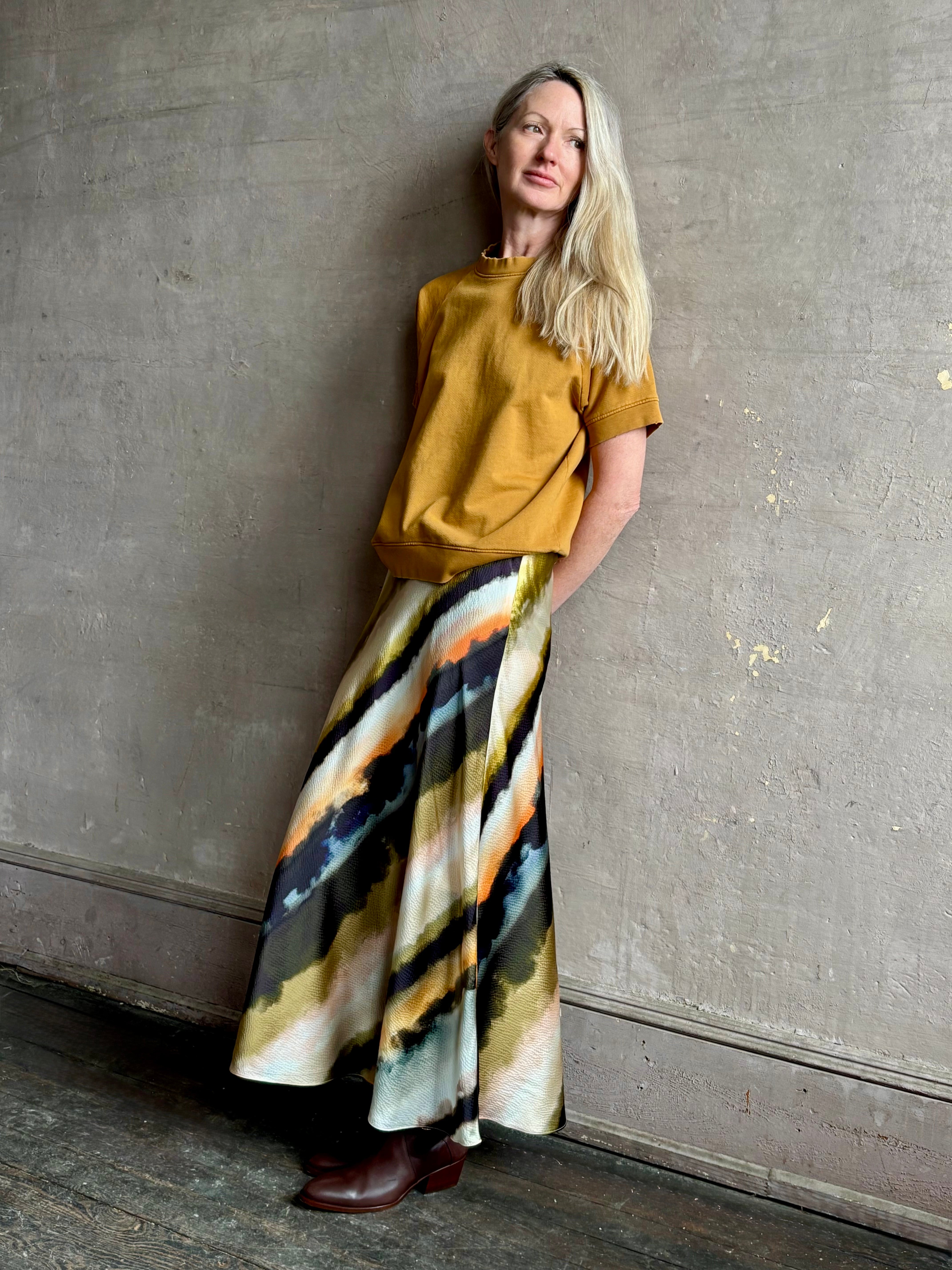 Image of mature woman wearing  designer Cara Cara hammered silk maxi slip skirt with abstract multi-color print that can be dressed up or down