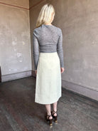 Image of woman wearing the Luca midi skirt with classic A line silhouette and textured tweed fabrication by Cara Cara