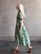 Woman wearing Cara Cara designer Malena cotton poplin shirt dress in a green Hudson Scarf Mint print with short sleeves ad belt