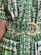 Woman wearing Cara Cara designer Malena cotton poplin shirt dress in a green Hudson Scarf Mint print with short sleeves ad belt