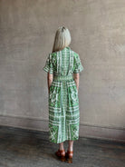 Woman wearing Cara Cara designer Malena cotton poplin shirt dress in a green Hudson Scarf Mint print with short sleeves ad belt
