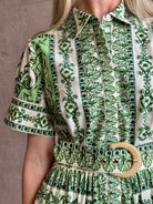 Woman wearing Cara Cara designer Malena cotton poplin shirt dress in a green Hudson Scarf Mint print with short sleeves ad belt