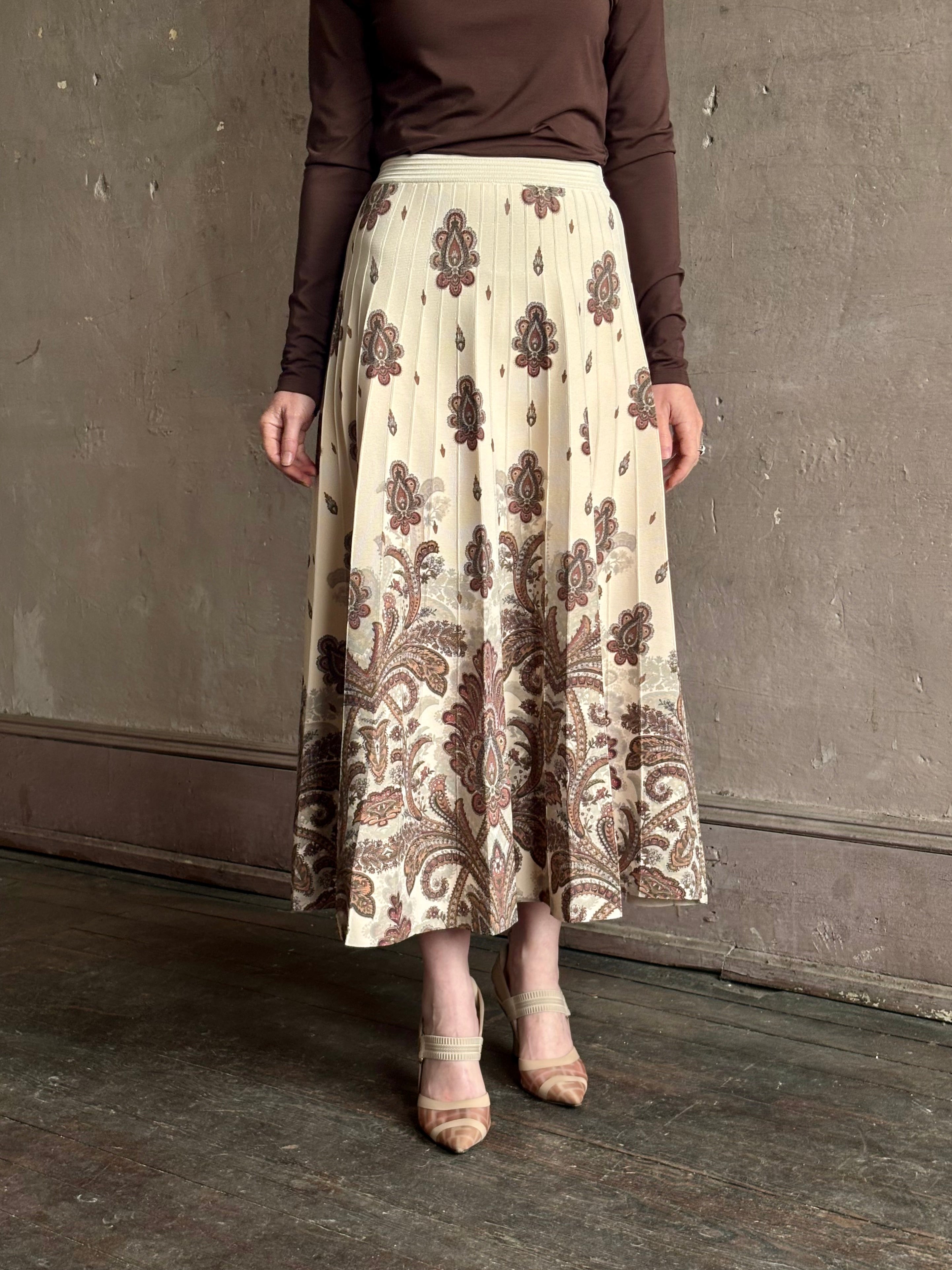Mature woman wearing designer Cara Cara Tavira A-line Skirt in Castle Paisley Ivory heavy knit tonal paisley print understated everyday sophistication