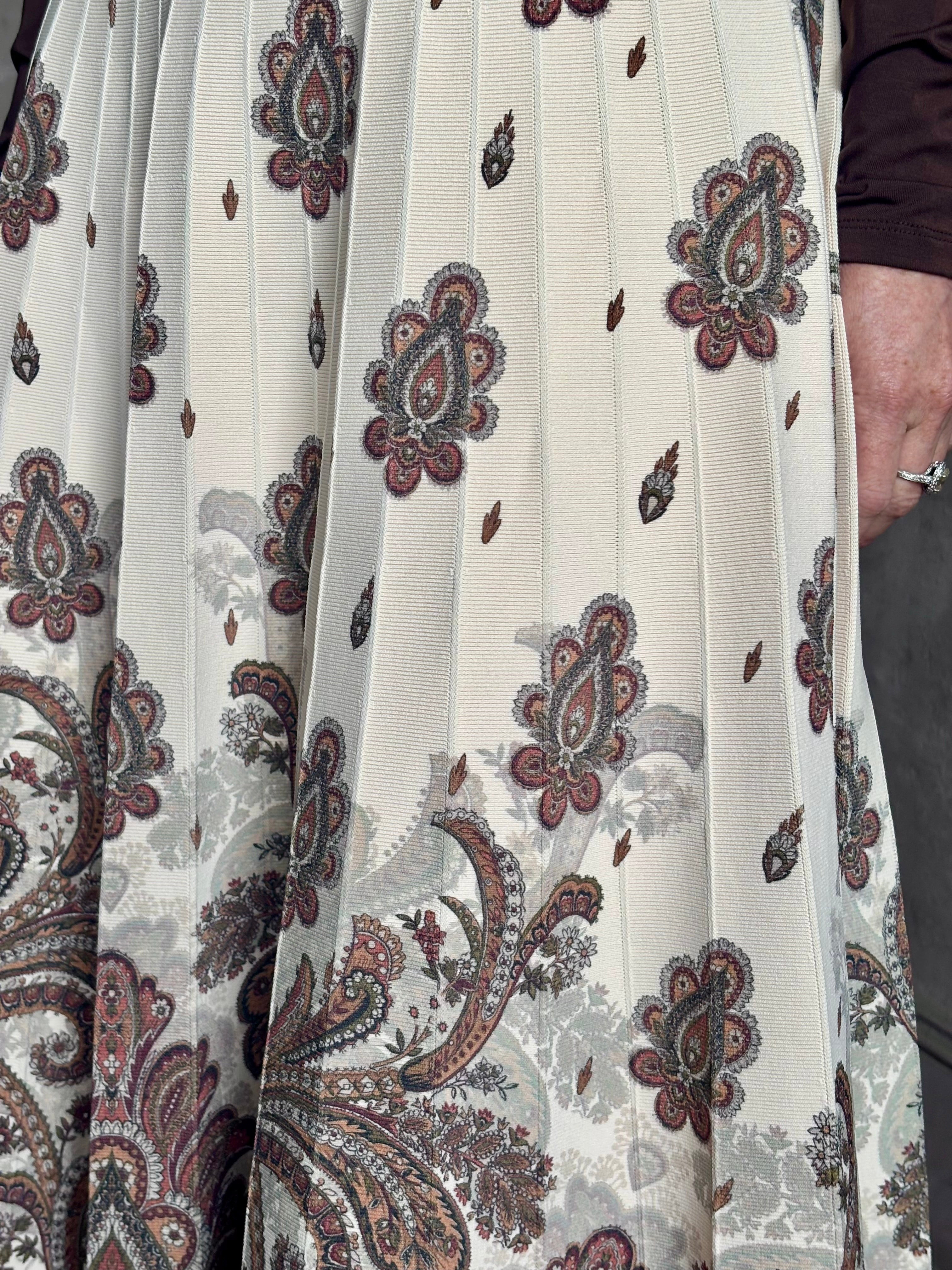 Mature woman wearing designer Cara Cara Tavira A-line Skirt in Castle Paisley Ivory heavy knit tonal paisley print understated everyday sophistication