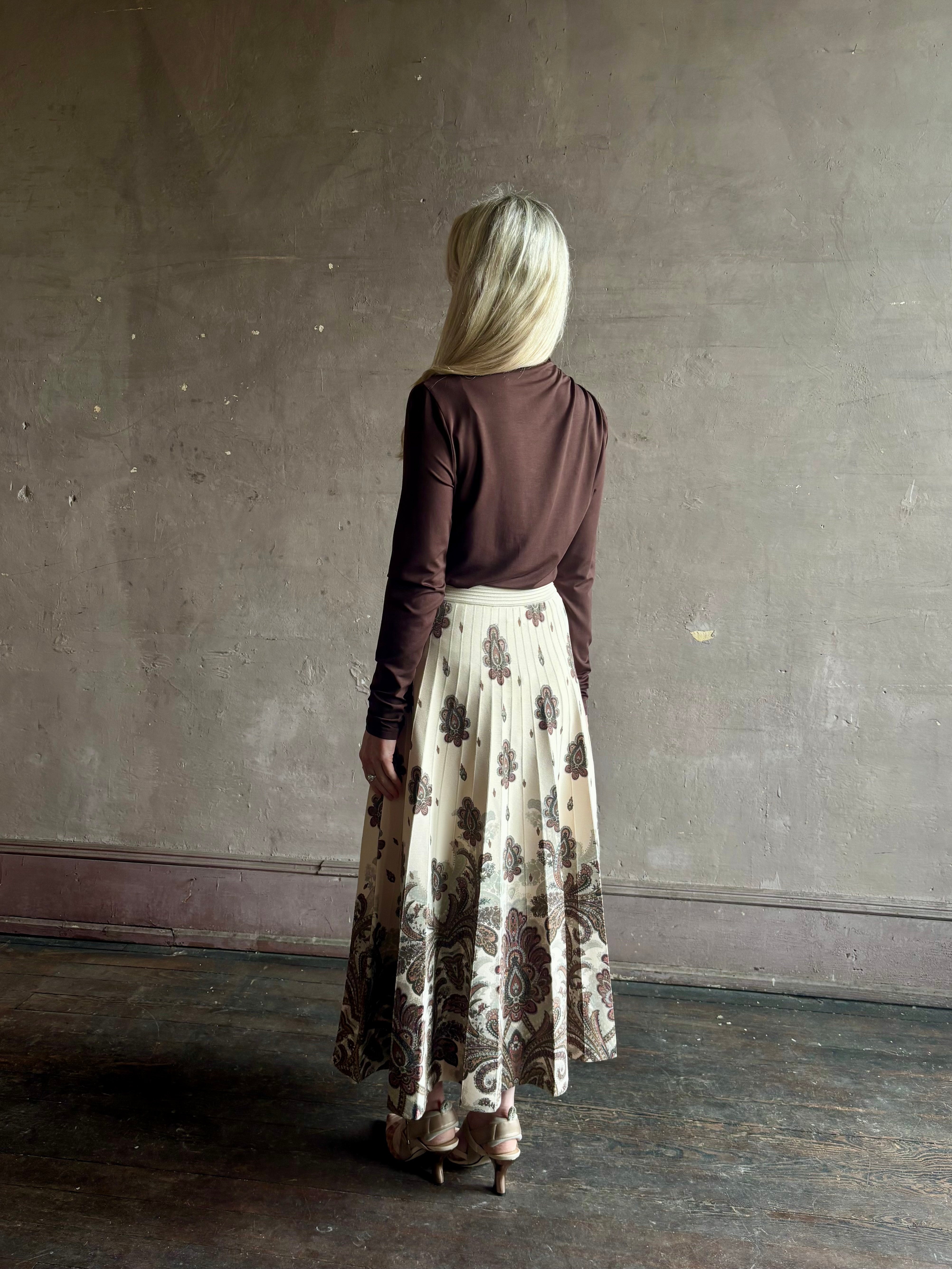 Mature woman wearing designer Cara Cara Tavira A-line Skirt in Castle Paisley Ivory heavy knit tonal paisley print understated everyday sophistication