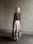 Mature woman wearing designer Cara Cara Tavira A-line Skirt in Castle Paisley Ivory heavy knit tonal paisley print understated everyday sophistication