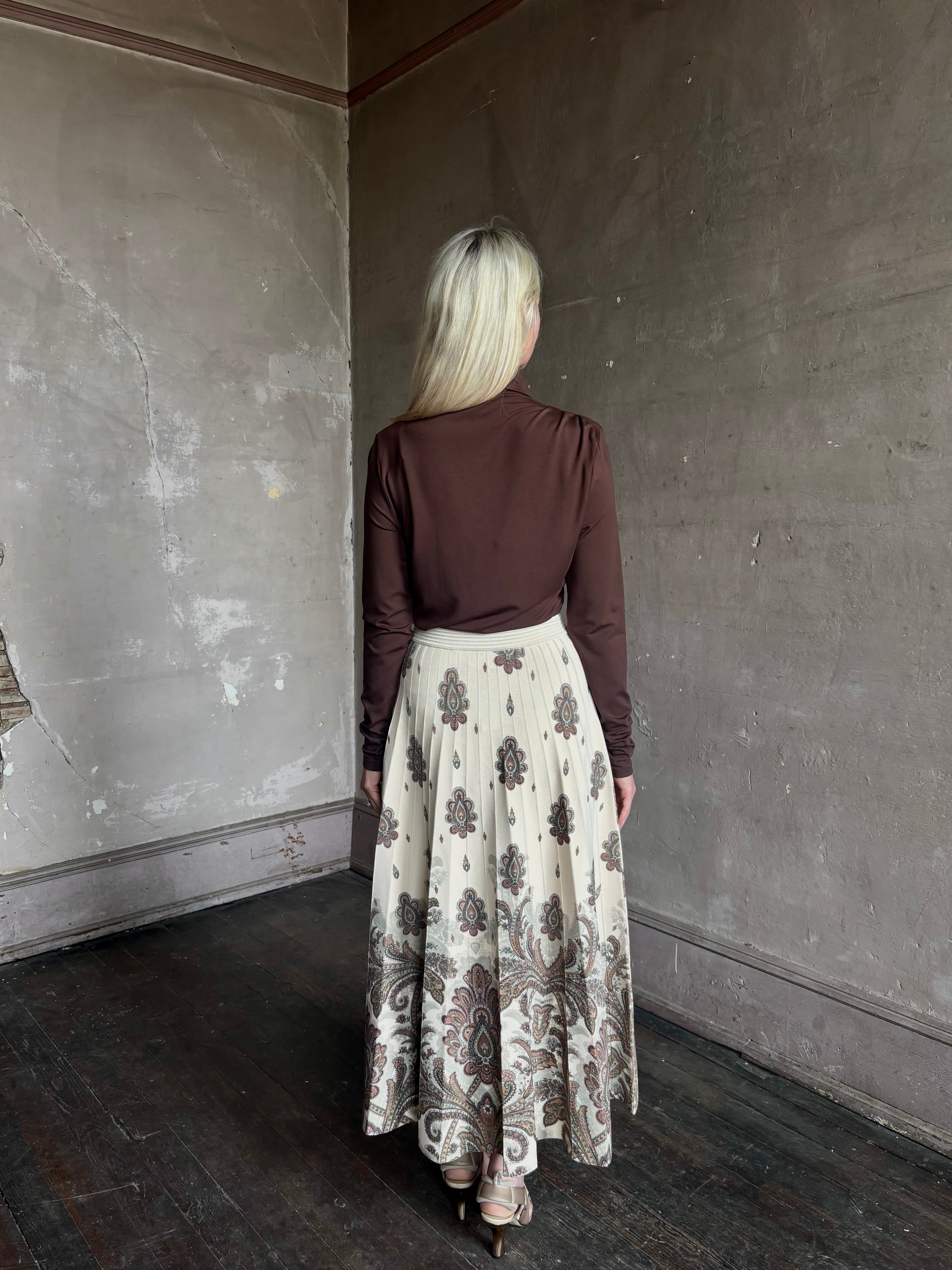 Mature woman wearing designer Cara Cara Tavira A-line Skirt in Castle Paisley Ivory heavy knit tonal paisley print understated everyday sophistication