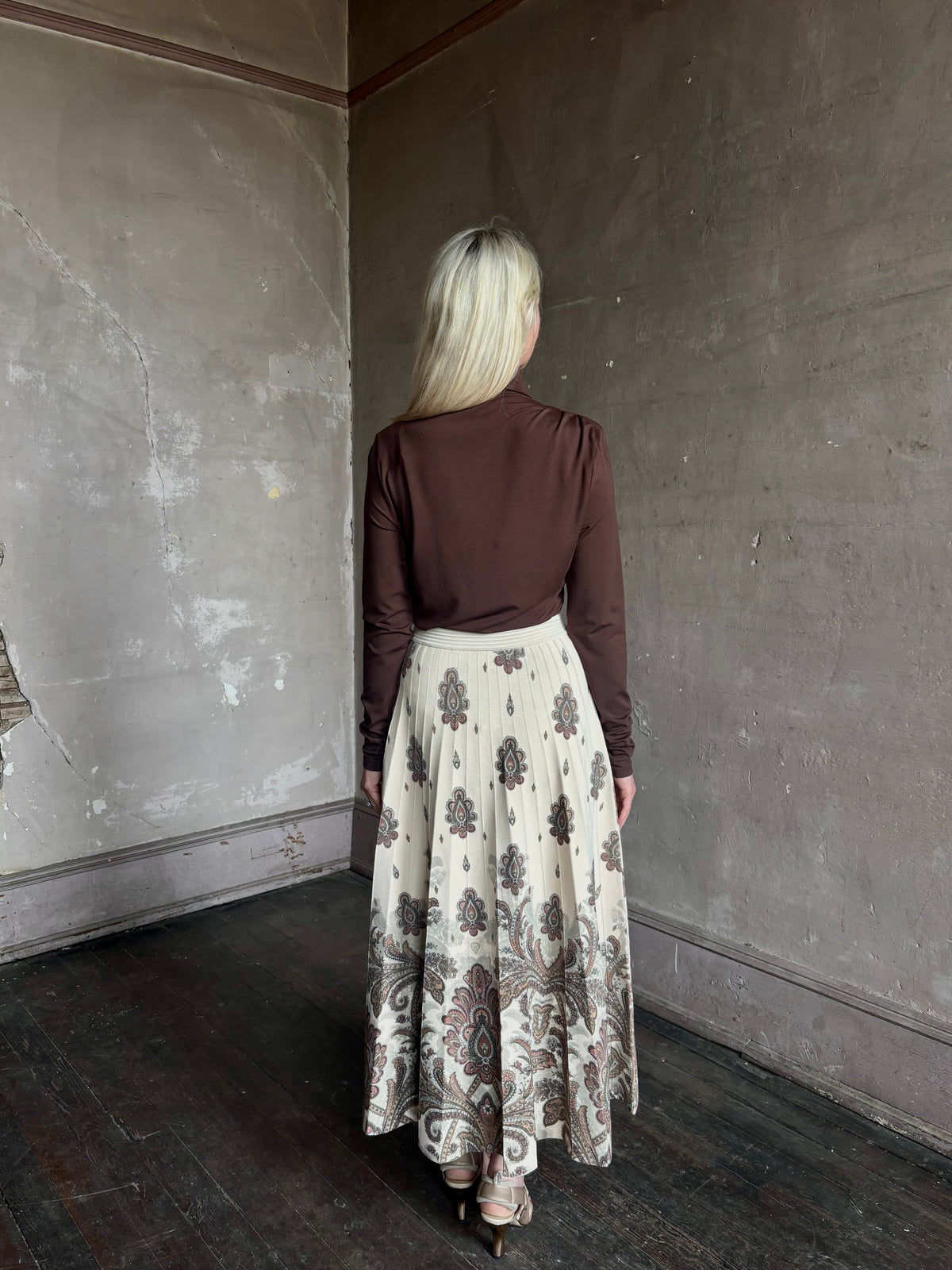 Mature woman wearing designer Cara Cara Tavira A-line Skirt in Castle Paisley Ivory heavy knit tonal paisley print understated everyday sophistication