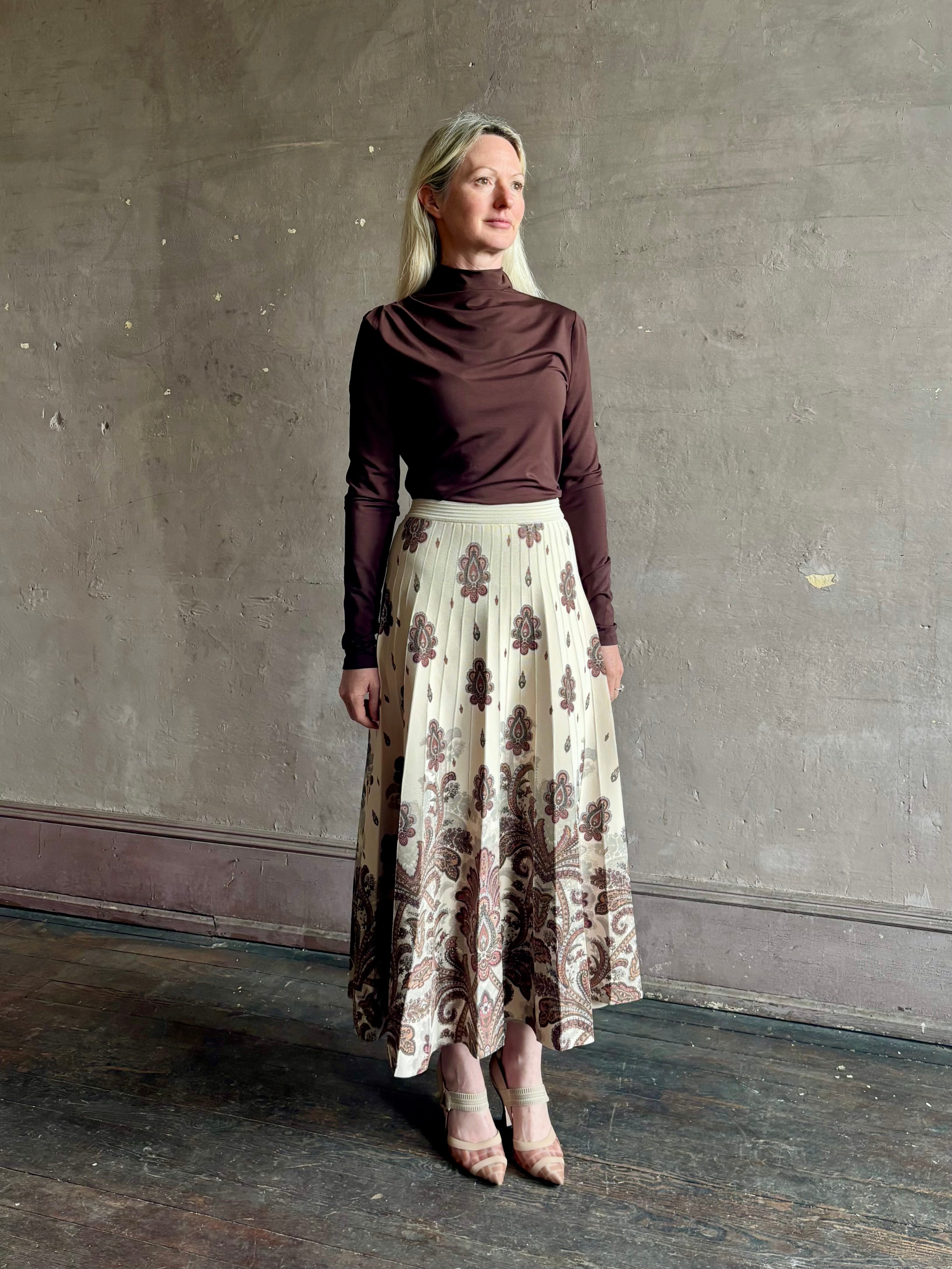 Mature woman wearing designer Cara Cara Tavira A-line Skirt in Castle Paisley Ivory heavy knit tonal paisley print understated everyday sophistication