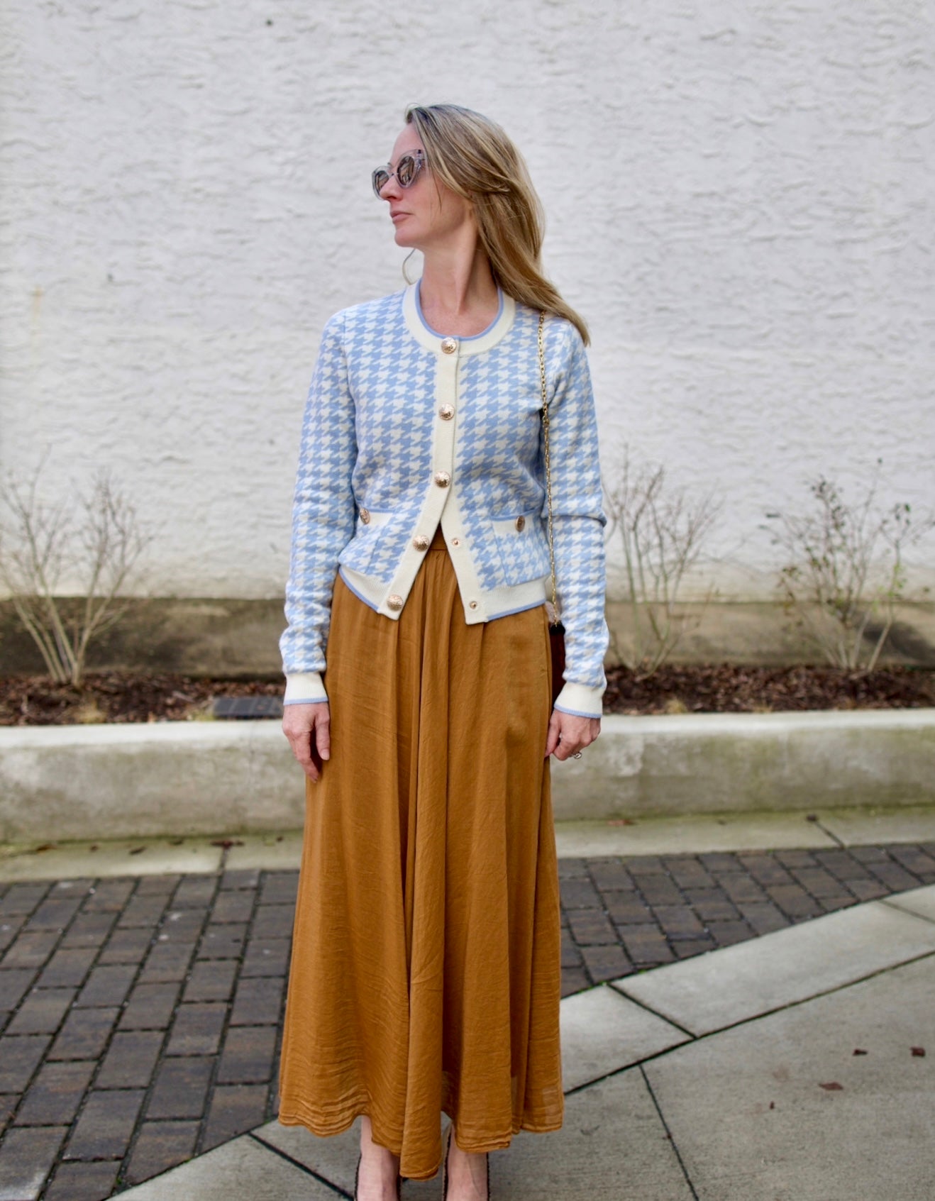 image of a woman wearing the Cara cara priscilla cardigan and Forte Forte Voile Skirt