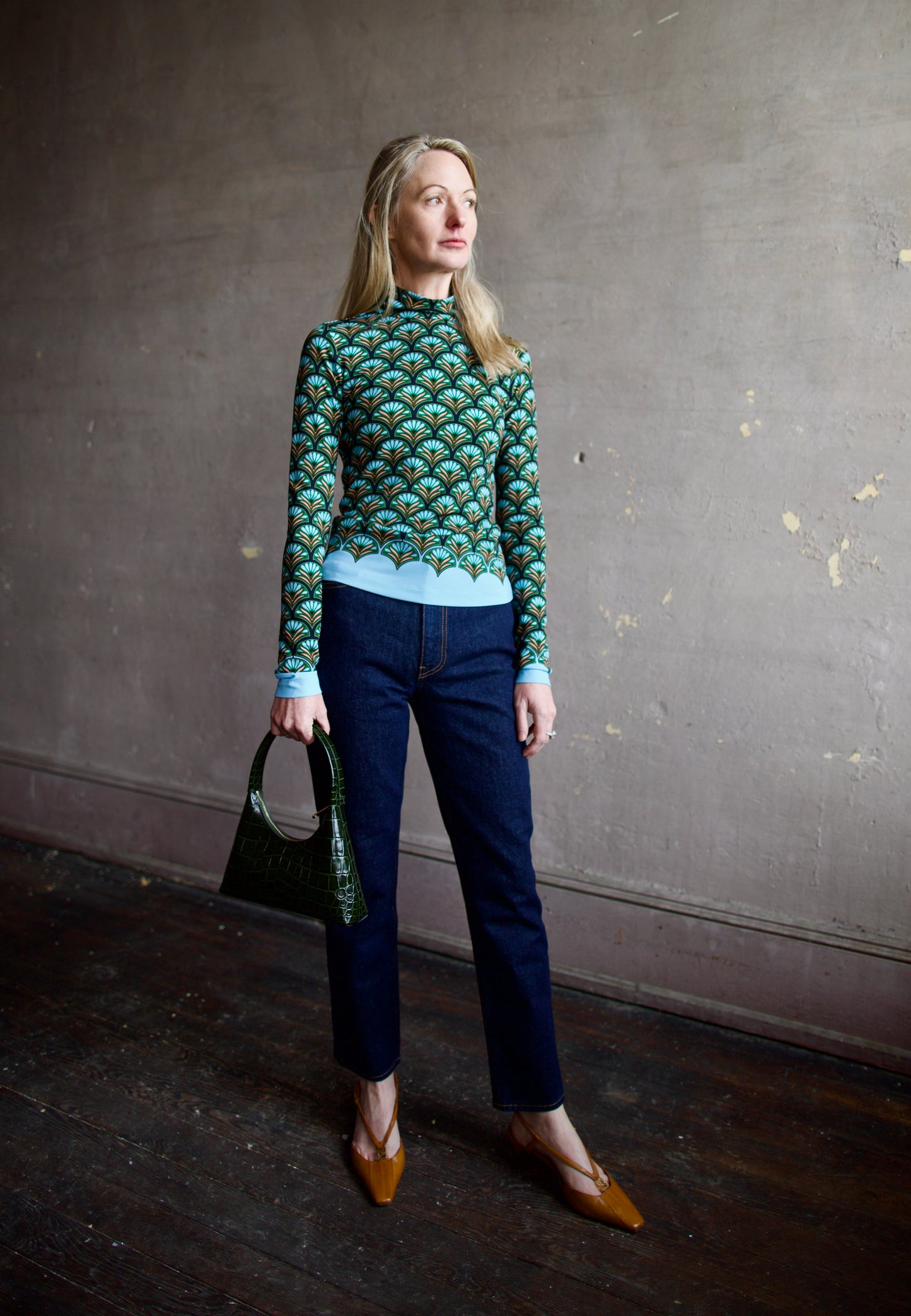 image of a woman wearing the cara cara suzie top, ulla johnson agnes jeans and mansur gavriel mini candy bag