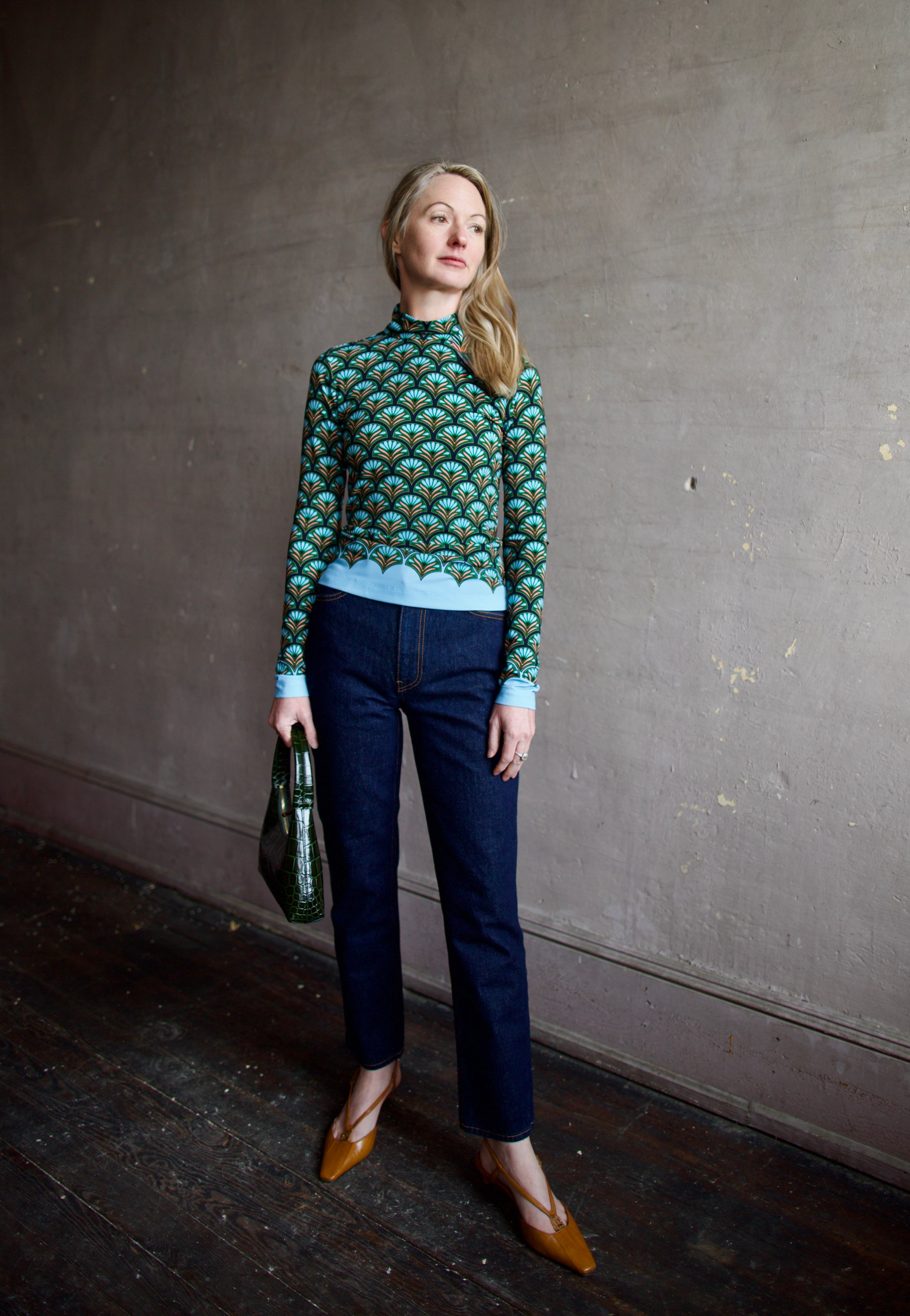 image of a woman wearing the cara cara suzie top, ulla johnson agnes jeans and mansur gavriel mini candy bag