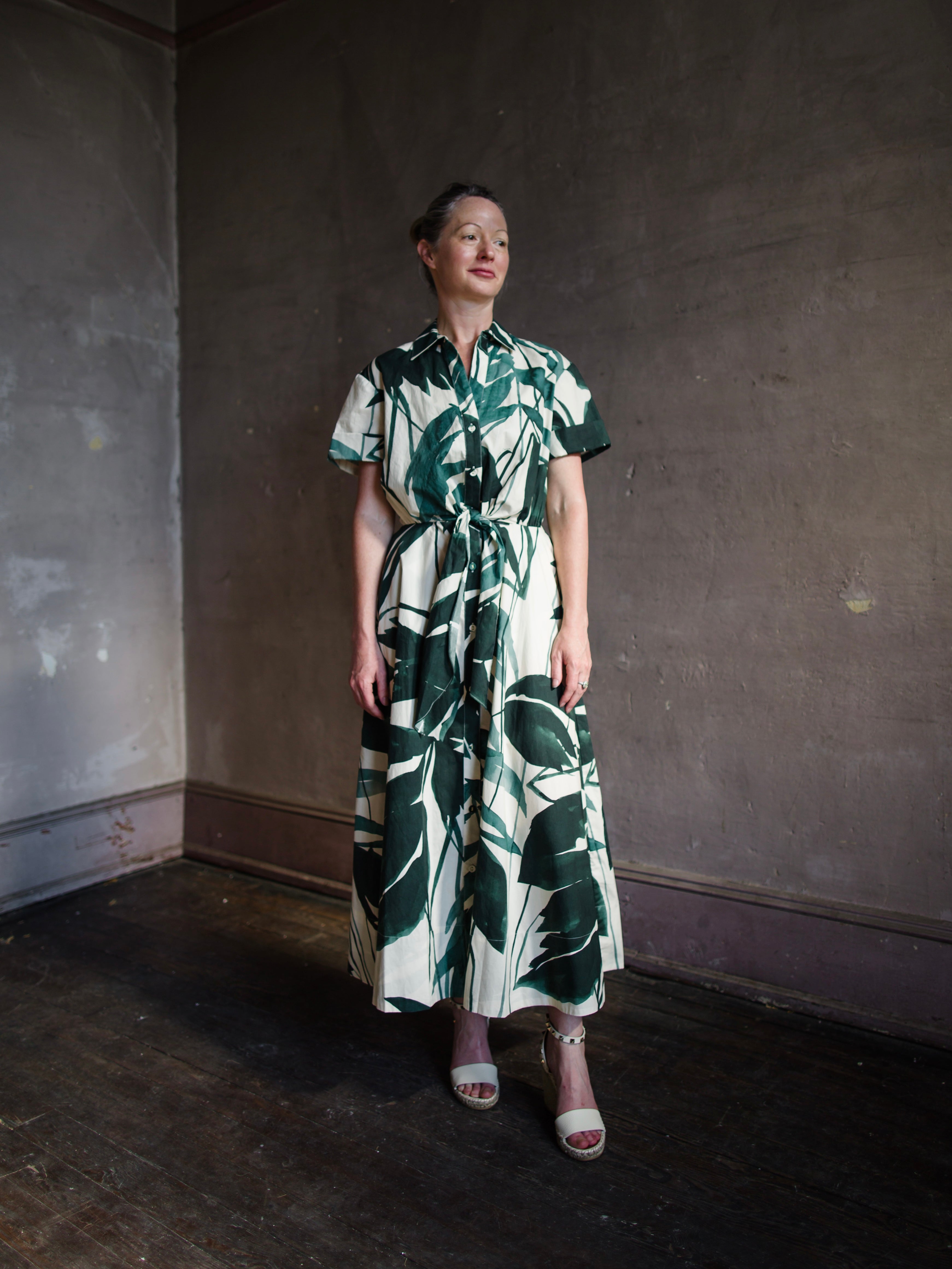 Image featuring a woman wearing the Asbury classic shirtdress from Cara Cara with a self-tie waist, short sleeves, side seam pockets, circle skirt, A-line silhouette, tea length.