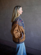 Side view image of a woman wearing the Cara Cara Ford Jacket and the slvrlake grace jeans