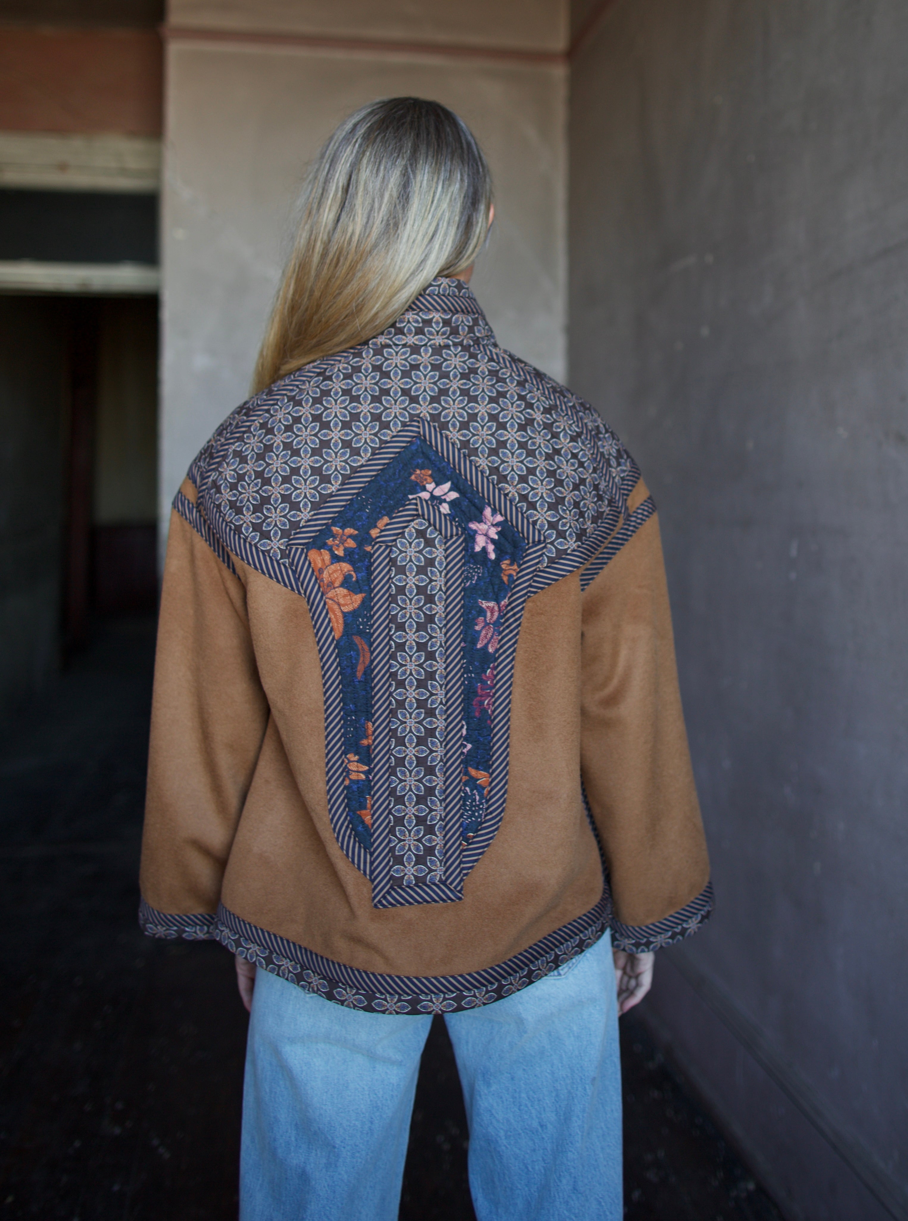 Image of the back of a woman wearing the Cara Cara Ford Jacket and the slvrlake grace jeans