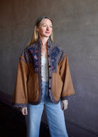 Image of a woman wearing the Cara Cara Ford Jacket, Enza Costa Ribbed Tank and the slvrlake grace jeans