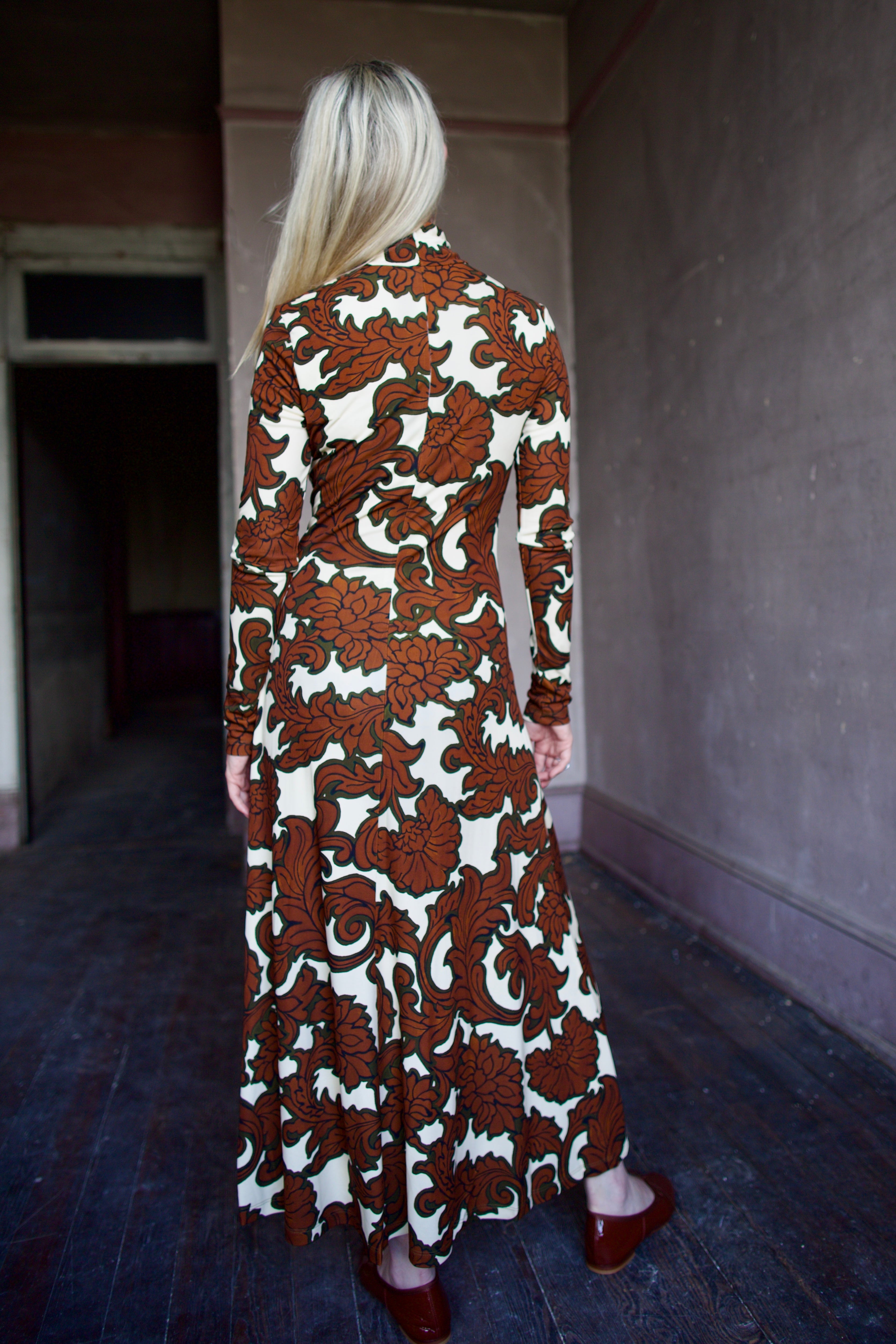 Model wearing the sophisticated patterned Hera dress by Cara Cara with a flattering A-line silhouette