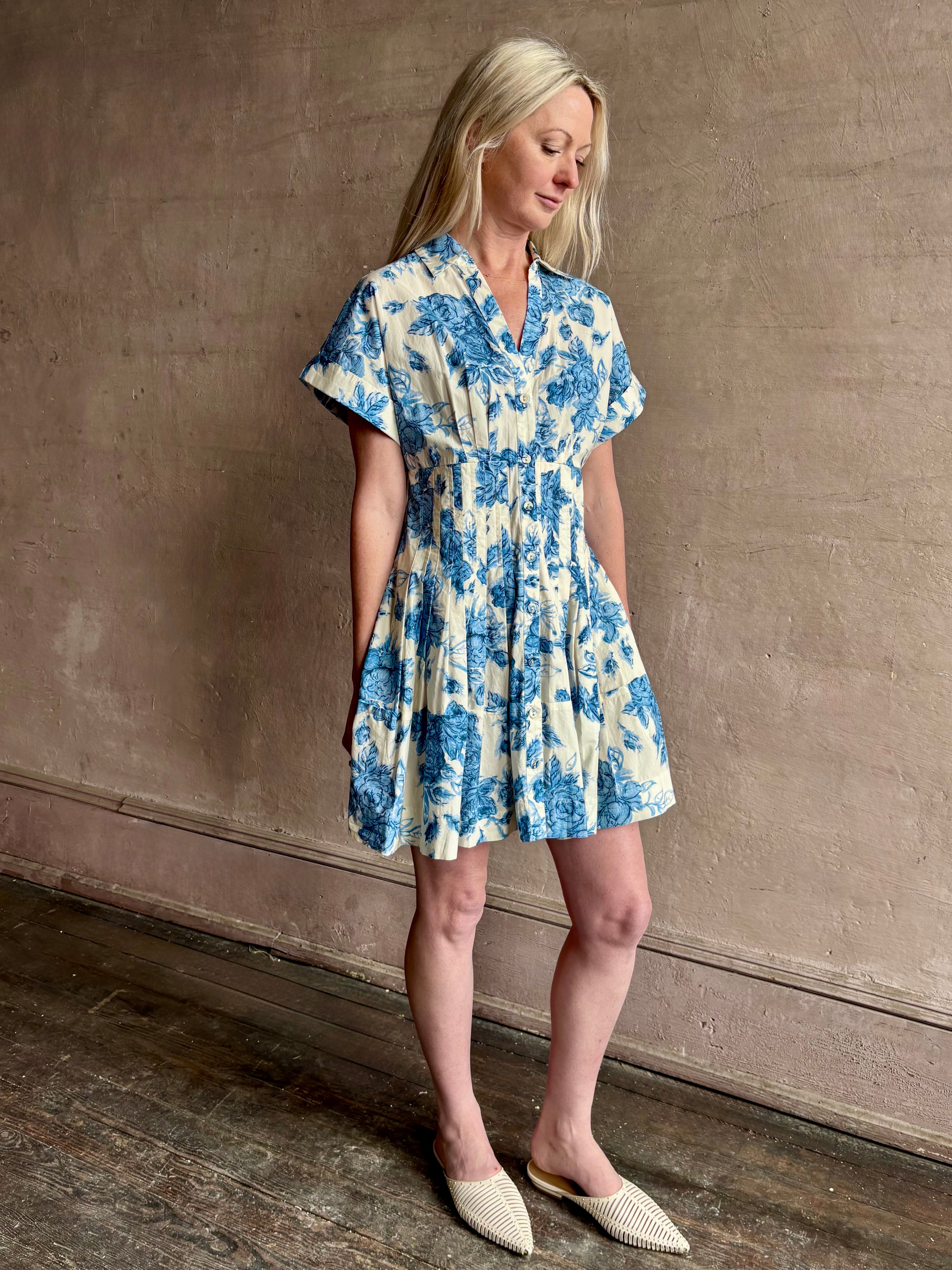 Image of woman wearing premium cotton poplin Cara Cara Nash Mini Dress in Tossed Floral Blue with v-neck short sleeves and pintucked waist detail