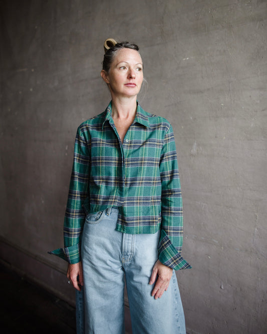 Image featuring a woman wearing the bib plaid top by Cissa with a button front, cropped, boxy fit in Green Plaid Japanese Flannel.