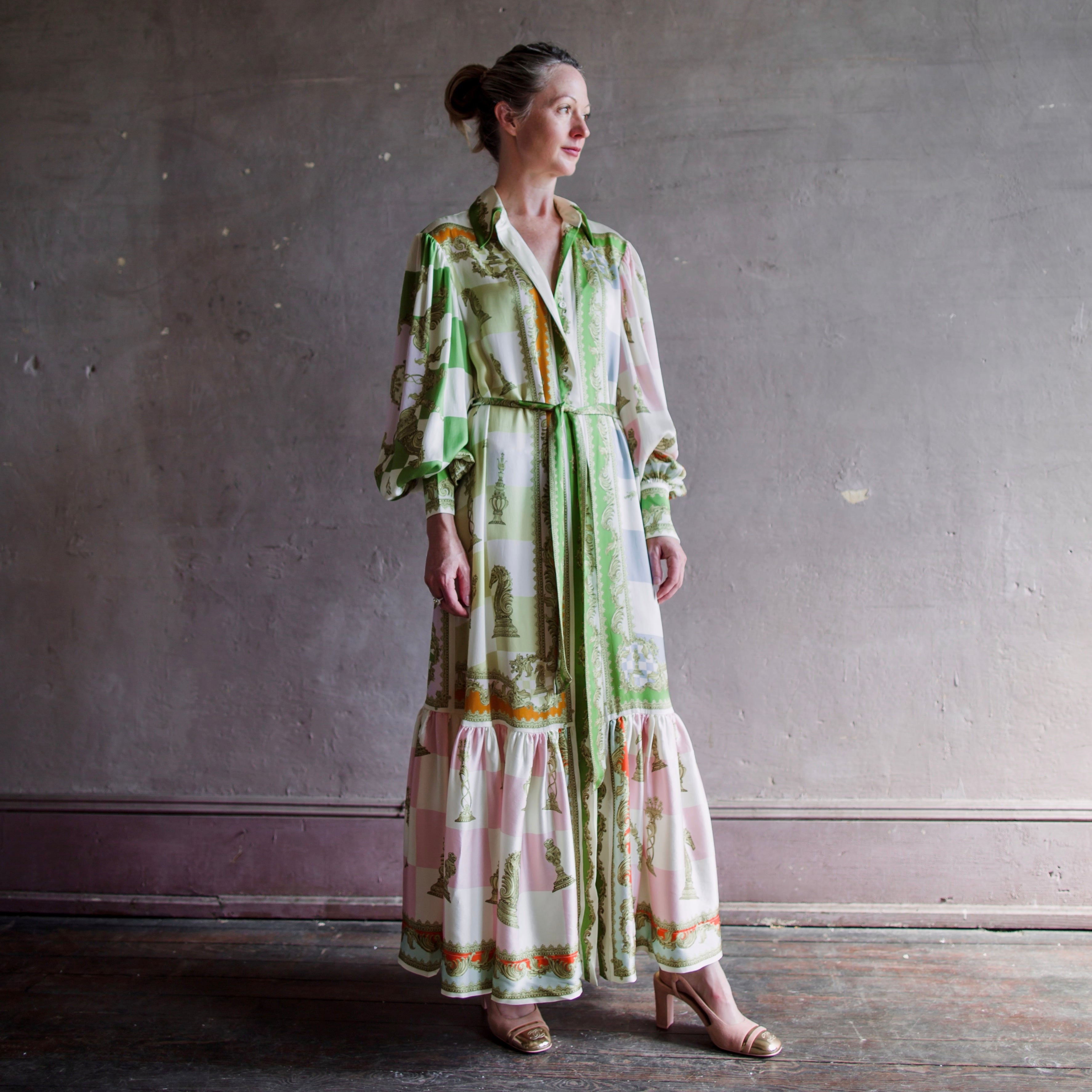 Image featuring a woman wearing the Checkmate midi shirtdress from Alemais with gathered balloon sleeve & button cuff, and a self-tie belt in sand washed silk.