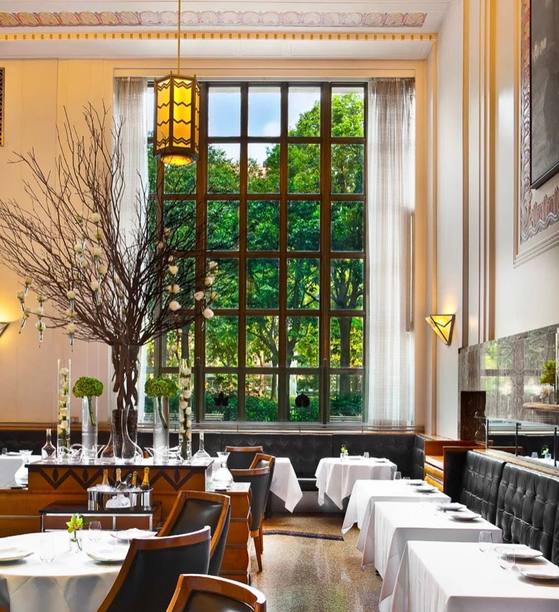 Image showing the interior of Eleven Madison Park restaurant on the left and the front cover of 'The Cookbook