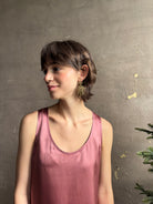 Woman wearing Solaris post Earrings from New York fine jewelry artist Emilie Shapiro that channels the radiant, life-giving energy of the sun in an exquisitely handcrafted textured brass form. Large, statement-making and thoroughly wearable dangle earrings