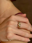 Woman wearing a White Sapphire statement Ring from contemporary fine jewelry designer Emilie Shapiro composed of three round white sapphires set in 14k yellow gold handcrafted in USA