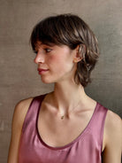 Woman wearing White Sapphire Pendant Necklace from fine jewelry designer Emilie Shapiro  exquisitely handcrafted in USA and sustainably considered 14K yellow gold 