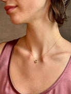 Woman wearing White Sapphire Pendant Necklace from fine jewelry designer Emilie Shapiro  exquisitely handcrafted in USA and sustainably considered 14K yellow gold 